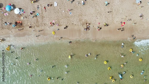 People who enjoy swimming on the transparent and clean beach. Jeju Island.
