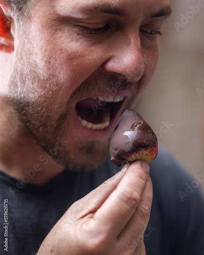 Fotografie Eating fresh strawberries as a concept