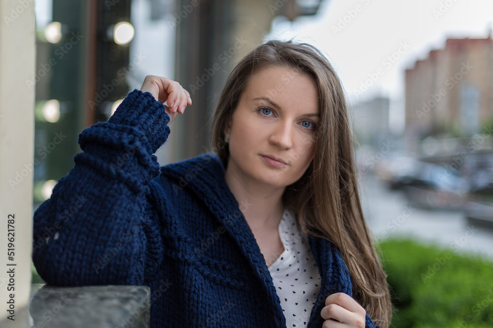 custom made wallpaper toronto digitalStreet portrait of a young woman dressed in a blue cardigan, cute autumn outfit.