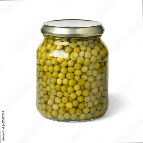Closed glass jar with small green peas isolated on white background