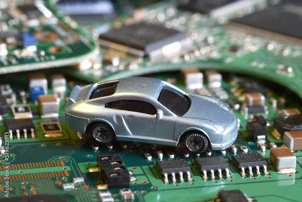 Toy cars on electronic board and microchip. Conceptual image for