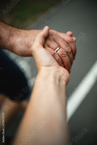 A guy holds a girl by the hand, a young couple walks in the park holding hands, a man pulls a woman behind him,