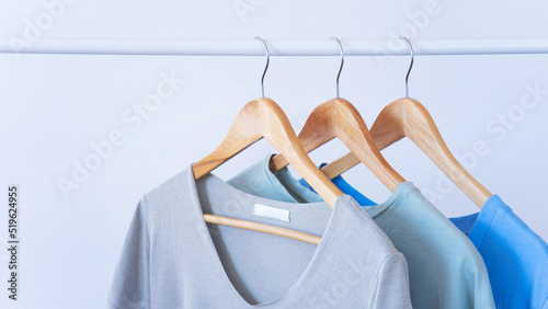 Women clothes hanging on wooden hangers in the store