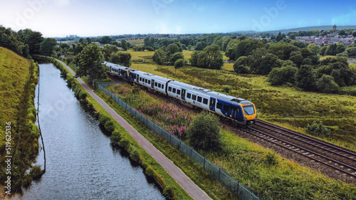 Aerial drone shot of a moving train near a river