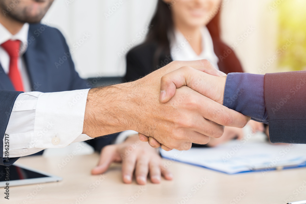 Business man shaking hands together after finishing up meeting in the office. Investment deal, Partnership concept. Business man shaking hands together after finishing up meeting in the office. Investment deal, Partnership concept.