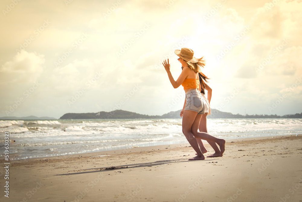 Portrait of two Happy traveller woman wearing straw enjoys her during summer tropical beach vacation