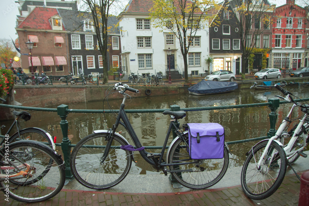  bike is parked near the house in Amsterdam.