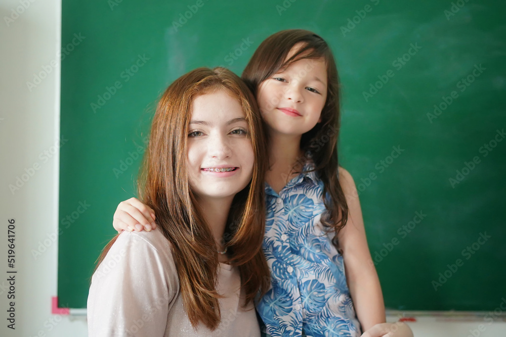 Preschool Girl Kid Drawing With Color Pencil On White Paper On Table In Classroom With Friends Preschool Girl Kid Drawing With Color Pencil On White Paper On Table In Classroom With Friends
