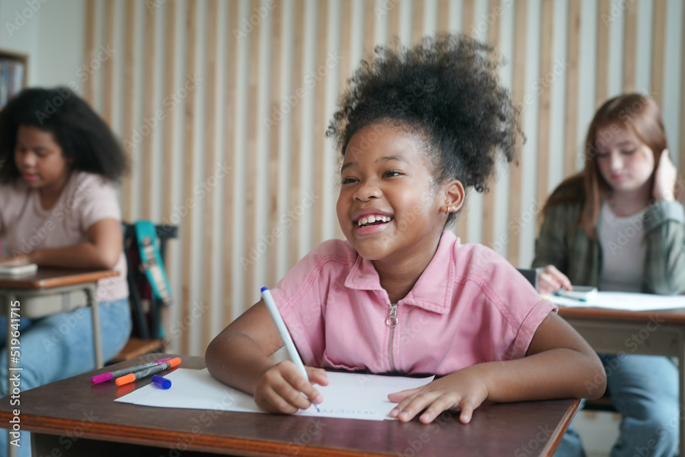 African kids drawing and do homework in classroom, young girl happy funny study and play painting on paper at elementary school. Kid drawing and painting at school African kids drawing and do homework in classroom, young girl happy funny study and play painting on paper at elementary school. Kid drawing and painting at school
