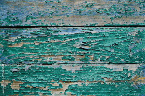 A fragment of a wall made of wooden clapboard painted in green