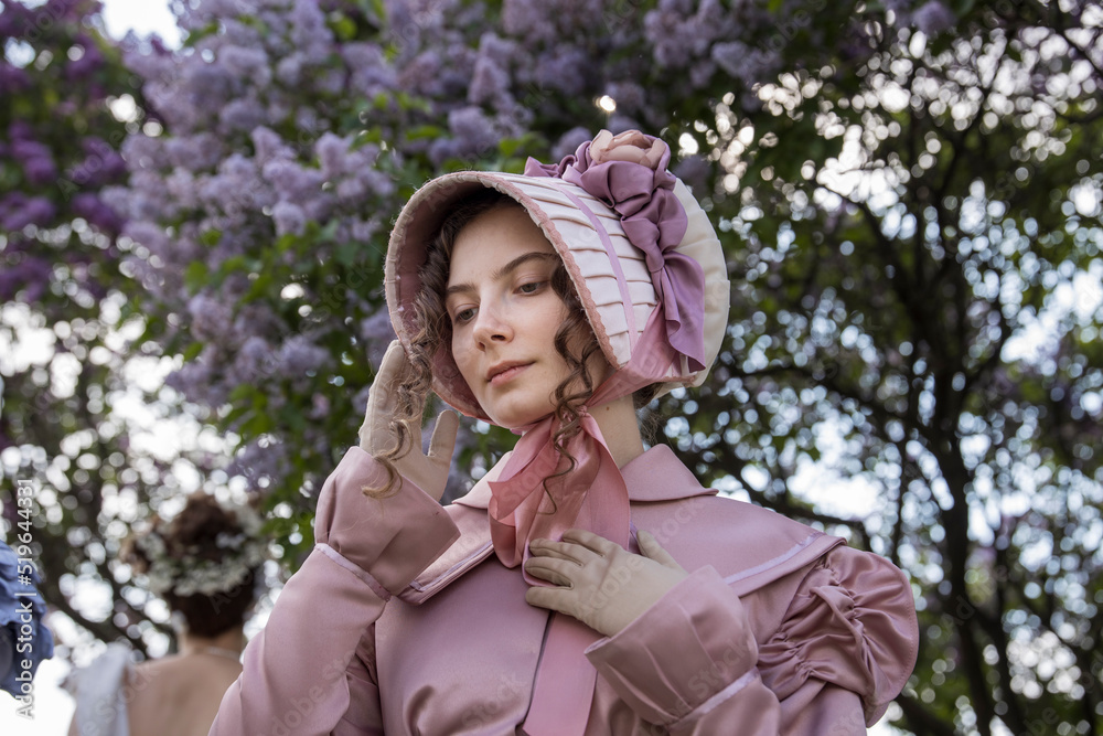 Young woman in historical dress. Fashionable clothes of the 19th century. Historical women's costume. Young woman in historical dress. Fashionable clothes of the 19th century. Historical women's costume.