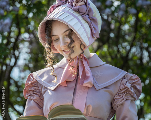 Billede på lærred Young woman in vintage 19th century dress.holding a book