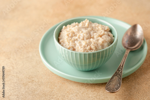 Oatmeal porridge  in a bowl on a table. Healthy food photo
