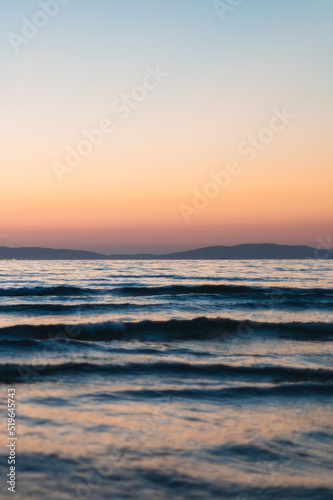 sunset on the beach with mountains