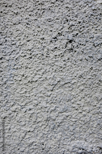 Pale grey rough wall with texture, grey background