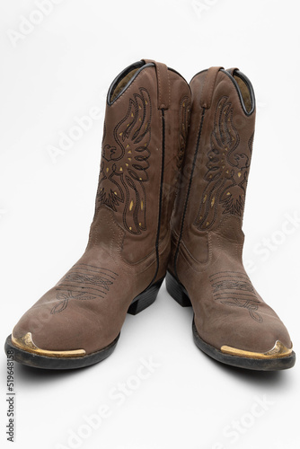 Studio photo of brown leather women's cowboy boots. The background is white. 