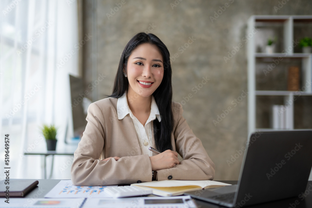 Confident and attractive Asian business woman Sit back and relax at work with your arms crossed, smiling and looking at the camera in the office. Confident and attractive Asian business woman Sit back and relax at work with your arms crossed, smiling and looking at the camera in the office.