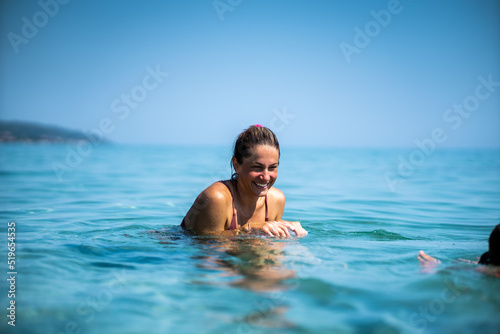 Portrait of smiling young woman in sea. Vacation concept.