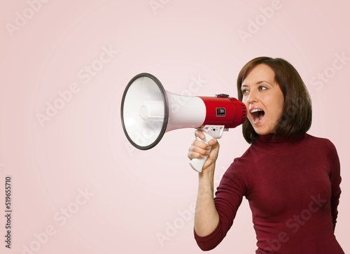 Young smiling expressive happy student woman screaming shouting hot news in megaphone