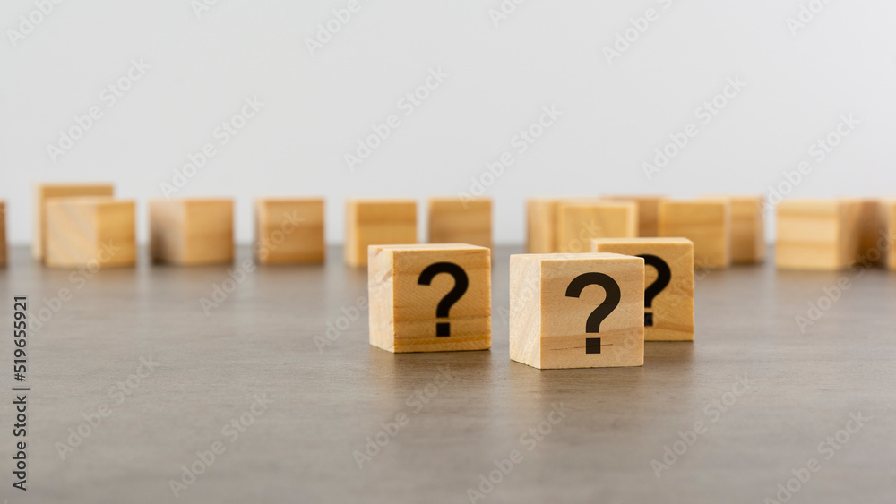 cube with question mark on wooden background. space for text cube with question mark on wooden background. space for text