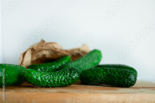 Fresh green cucumbers on a wooden table