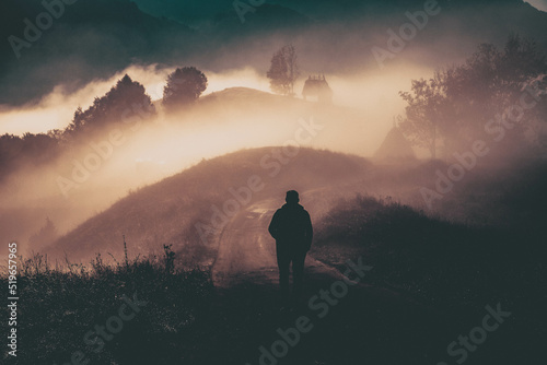 man walking in a foggy autumn landscape