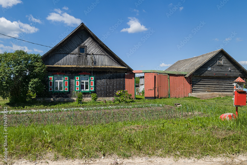 Old wooden house with very beautiful old multicolor wooden windows, Latvia. Old wooden house with very beautiful old multicolor wooden windows, Latvia.