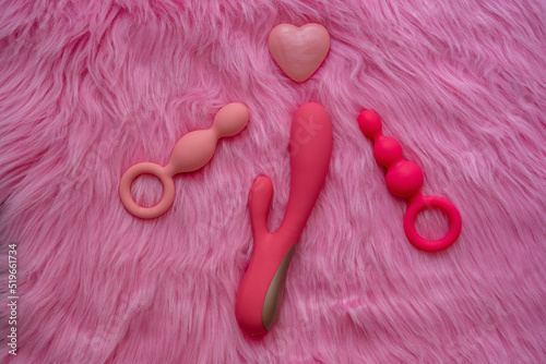 sex toys on pink background, love heart photo