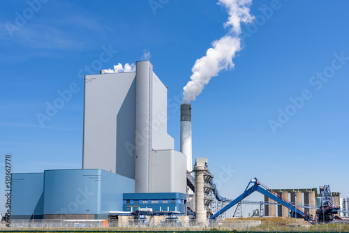 Large coal and biomass power plant on a clear summer day