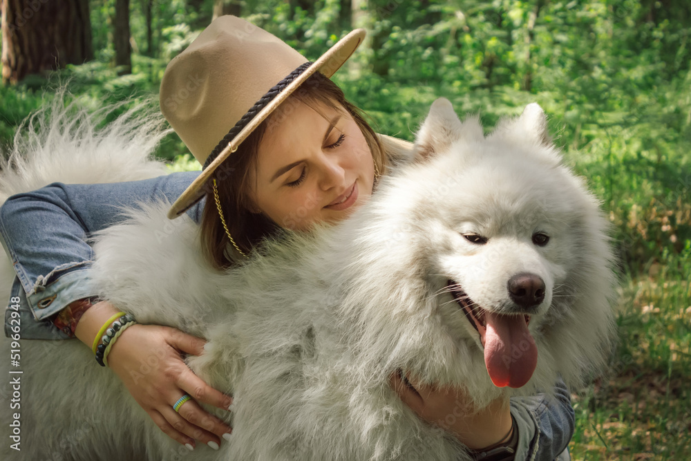 Woman hugging her dog samoyed at forest Woman hugging her dog samoyed at forest