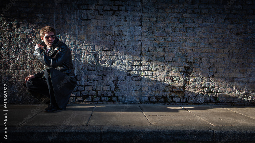Undercover; compromised. A spy has his shadow cover blown by a passing car; from a series of images with the same character. Undercover; compromised. A spy has his shadow cover blown by a passing car; from a series of images with the same character.