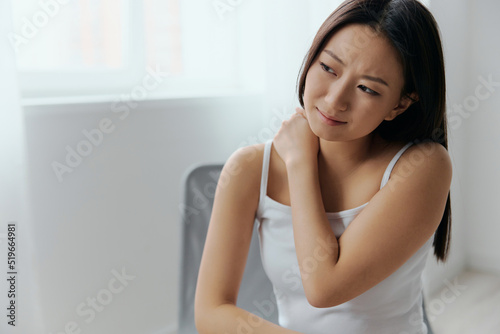 Free Download Suffering from shoulder dislocation neuralgia tanned beautiful young Asian woman touching painful shoulder at home interior living room. Injuries Poor health Illness concept. Cool offer Banner - GFXLoad