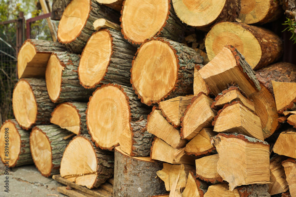 Stacked firewood outdoors, closeup. Heating in winter Stacked firewood outdoors, closeup. Heating in winter