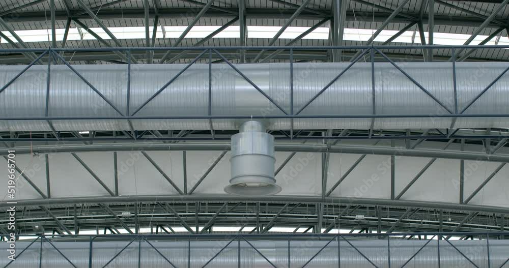 Air ventilation system in public premises. Metal constitution and ventilation pipe with a tip. Supply of fresh air to a large room. Diagonal connections of engineering. Air ventilation system in public premises. Metal constitution and ventilation pipe with a tip. Supply of fresh air to a large room. Diagonal connections of engineering.