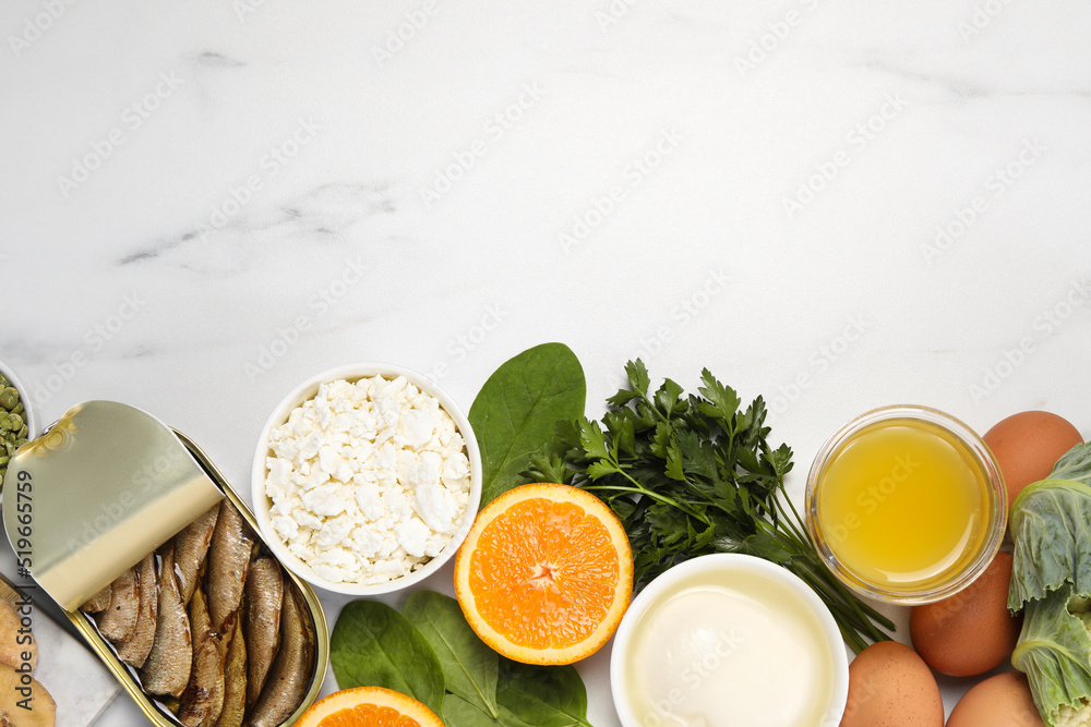 Set of natural food high in calcium on white marble table, flat lay. Space for text Set of natural food high in calcium on white marble table, flat lay. Space for text