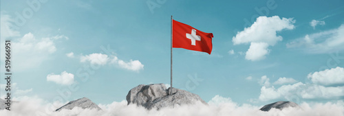 3d rendering of waving Swiss flag above sea of clouds to celebrate the national holiday of 1 august photo