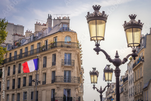 French flag winding and parisian architecture in Paris, France