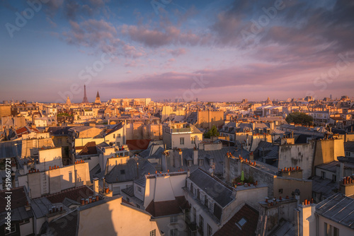 Eiffel tower and parisian roofs at sunrise Paris, France