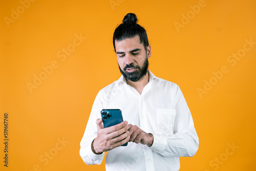 Focused ethnic manager using smartphone © Dalay