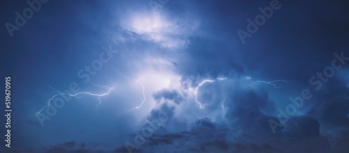 Photos Lightning in the blue sky with clouds at night.