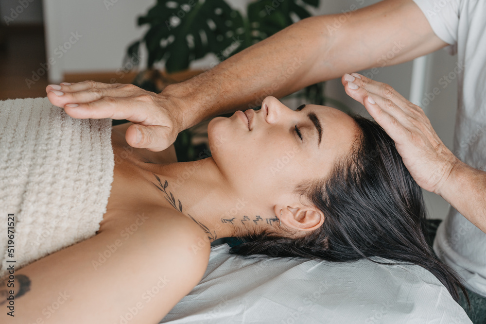Fototapeta premium Profile of a woman while receiving energy in a Reiki therapy