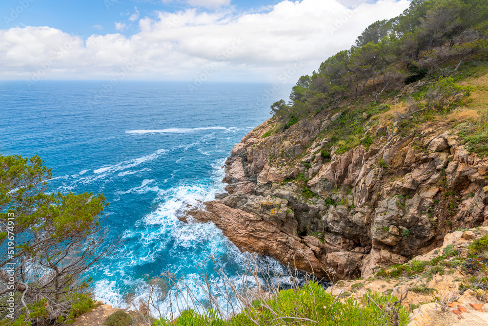 A rocky, steep coastline along the Costa Brava coastline at Tossa de Mar, Spain.