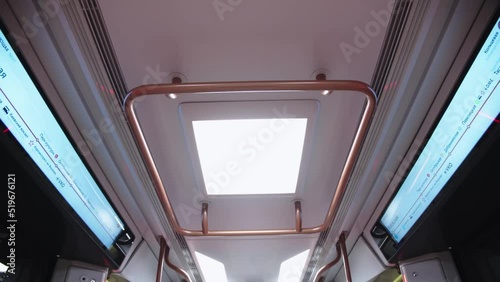 View of metro car ceiling with illumination and displays, showing the titles of moscow metropolitan stations in russian. subway car interior.