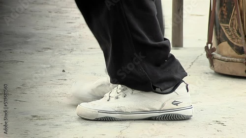 Young Male Dancer Doing Some Chacarera Steps, Chacarera is an Argentine Folklore Dance originated in Santiago del Estero province, Argentina. Low Angle View. Close Up.   photo