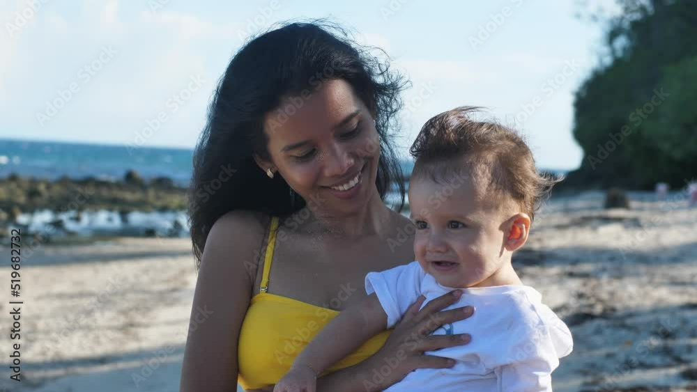 Portrait of a young Asian mother and her little baby smiling to the camera. Portrait of a young Asian mother and her little baby smiling to the camera.