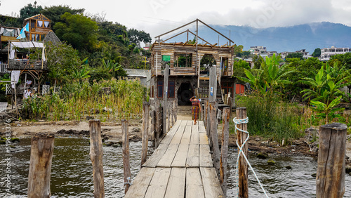 Fototapeta Naklejka Na Ścianę i Meble -  Beautiful view of the traditional Atitlan lake pier in the Guatemala  - with small towns and tourist boats