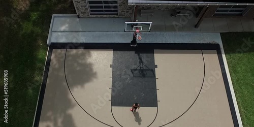 Drone Shot of a teenager shooting a free throw photo