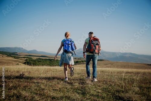 A group of tourists with backpacks are walking in mount