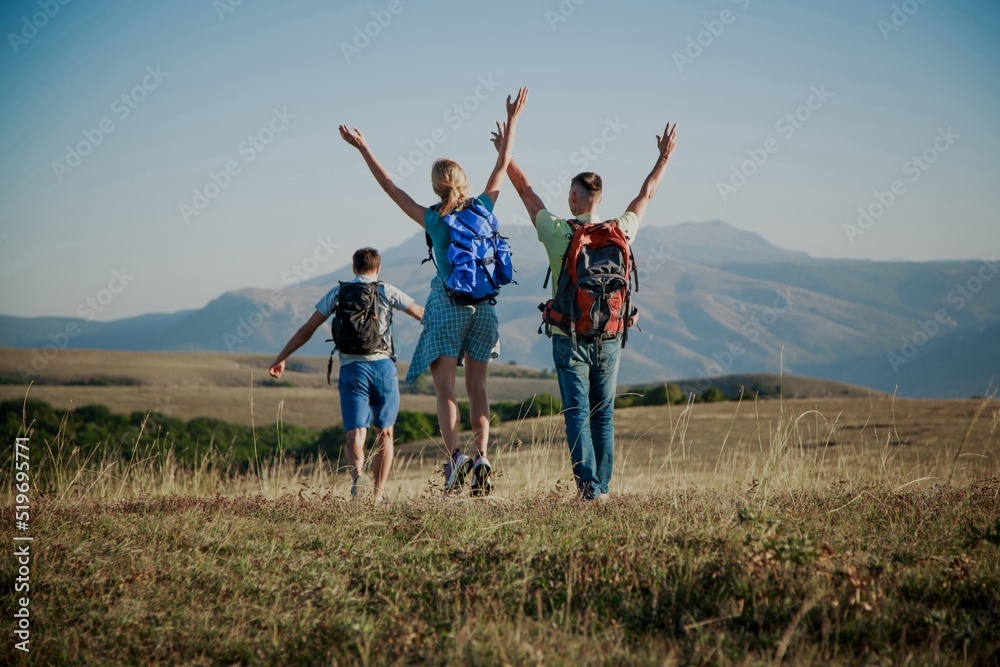 A group of tourists with backpacks are walking in mount A group of tourists with backpacks are walking in mount