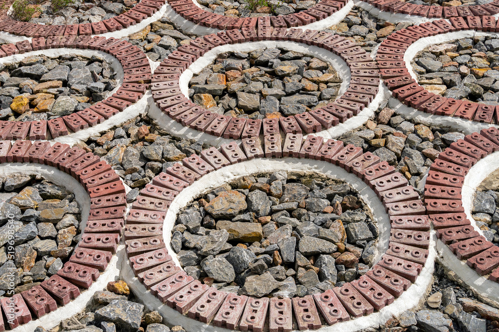 red brick pattern on stone background in park.